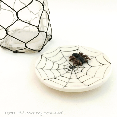 Cobweb design with small spider accent ceramic tea bag holder.