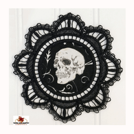 Black Doily with Skull Inset for Halloween Decorating. Skull faces left.