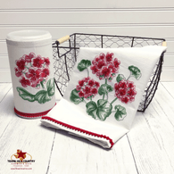 Red geranium floral design on white cotton dish towel and disinfecting wipes holder.