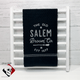 The Old Salem Broom Company logo embroidered on black towel.