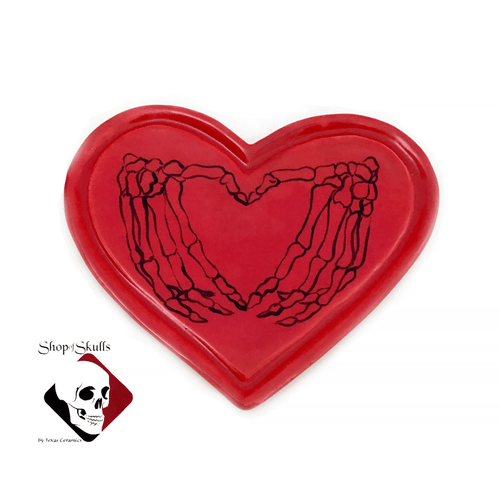 Red heart with sketched skeleton hands heart.