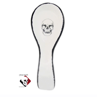 Long handle oval spoon rest with black skull design for Shop of Skulls by Texas Ceramics.