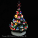 Vintage style ceramic Christmas tree with snow on its branches, color lights and a red star