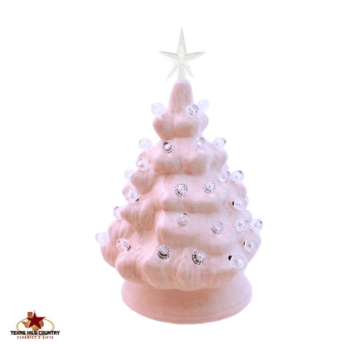 Pink ceramic Christmas tree with clear lights and star.