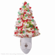 Ceramic Christmas tree night light in colors of peppermint, white, red and green.