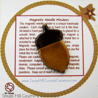 Acorn shaped magnetic needle minder for cross stitch, hand stitching or embroidery needle work, made in the USA.