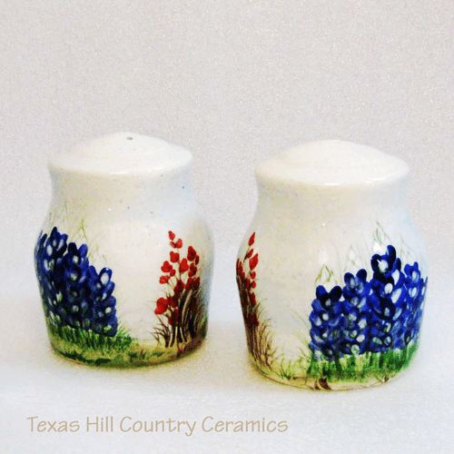 Ceramic pottery style salt and pepper shakers with hand painted bluebonnet wildflowers made in Texas.