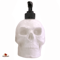 White skull soap dispenser with black pump unit.