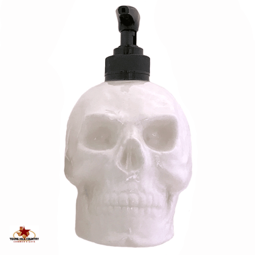 White skull soap dispenser with black pump unit.