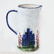 Tall slender ceramic pitcher with hand painted Texas Bluebonnet wildflowers made in the USA.