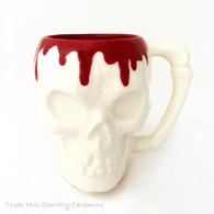 Skull mug with  oozing red over the edge, 8 ounce capacity.