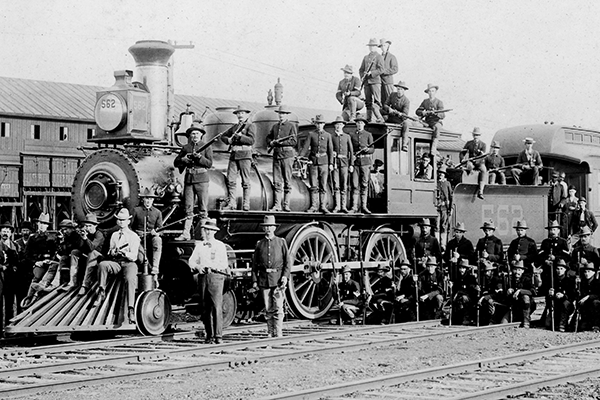 Armed Marshals and Soldiers Posed with a 4-4-0 Steam Locomotive